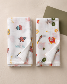 Maison Joey pack of two muslin swaddles in ice-cream and space-friends prints